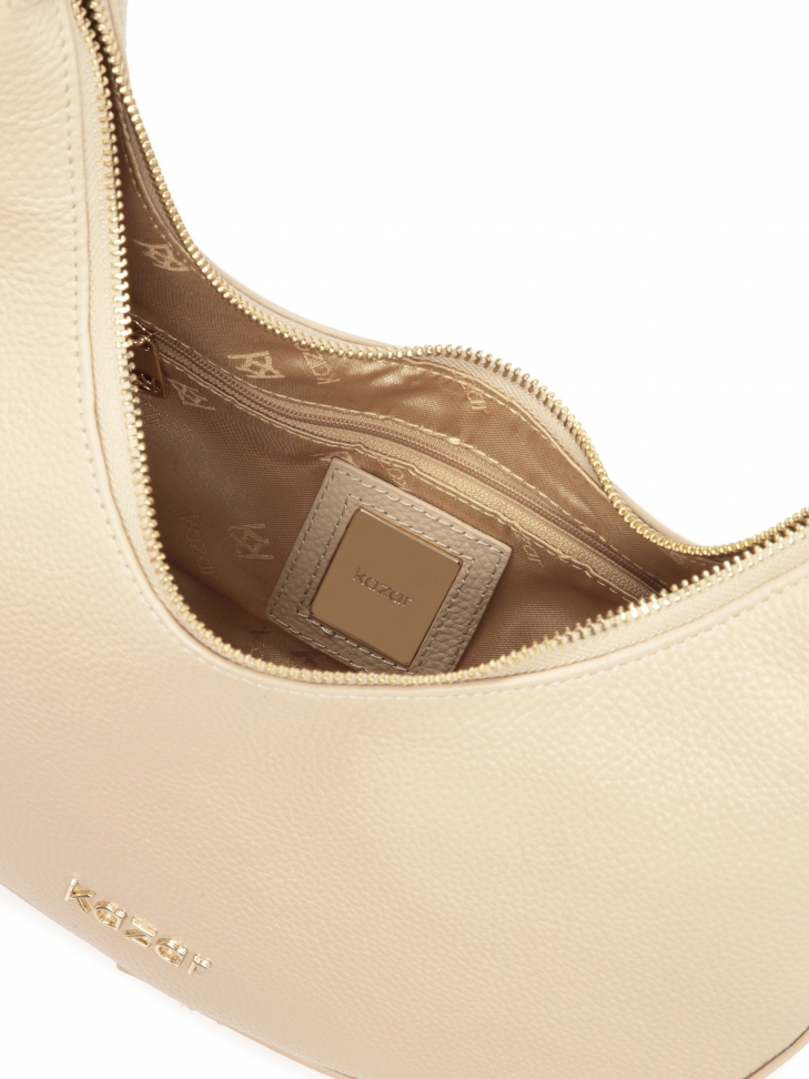 Beżowa torebka ze skóry o unikatowym kształcie