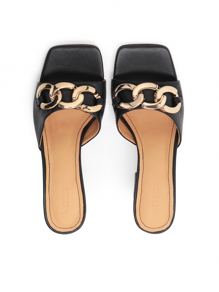 Skórzane klapki na słupku ozdobione grubym łańcuchem