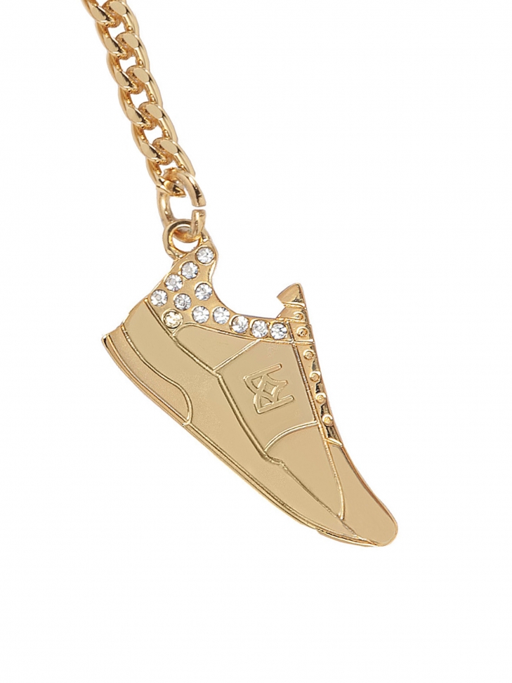 Mały metalowy brelok w kształcie buta