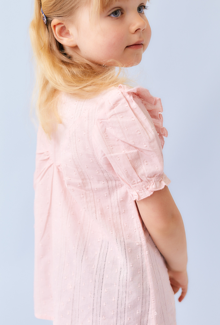 Różowa koszula dziewczęca z ótkim rękawem i falbanką.