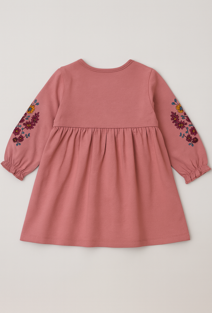 Różowa sukienka dziewczęca z haftem i falbanką.