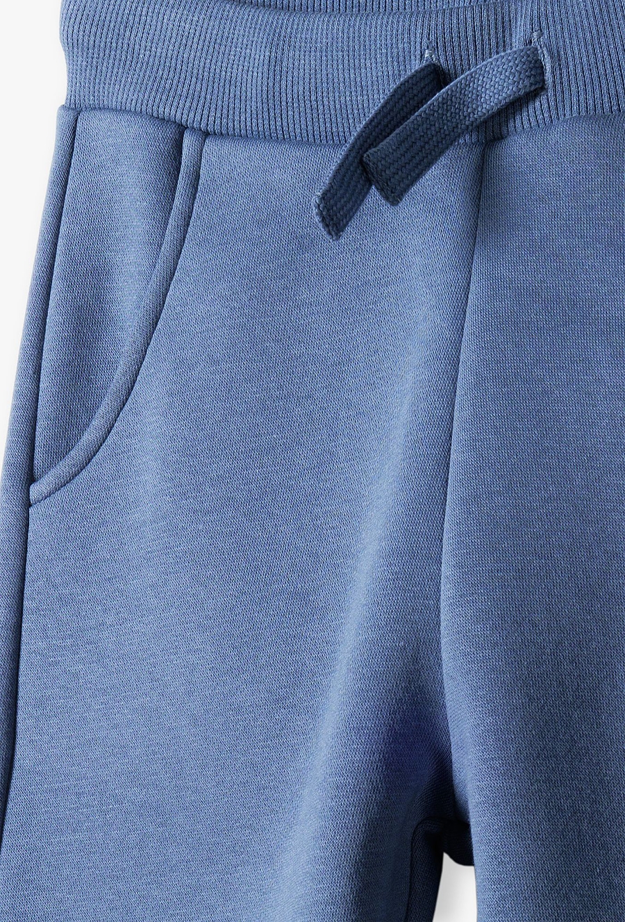 Spodnie dresowe niebieskie z napisem na nogawce- New generation