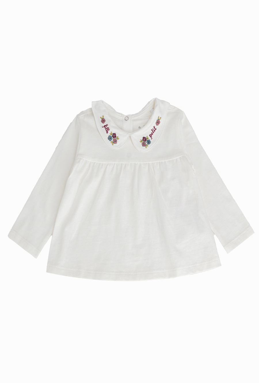 Biała bluzka dziewczęca z haftowanym kołnierzykiem.
