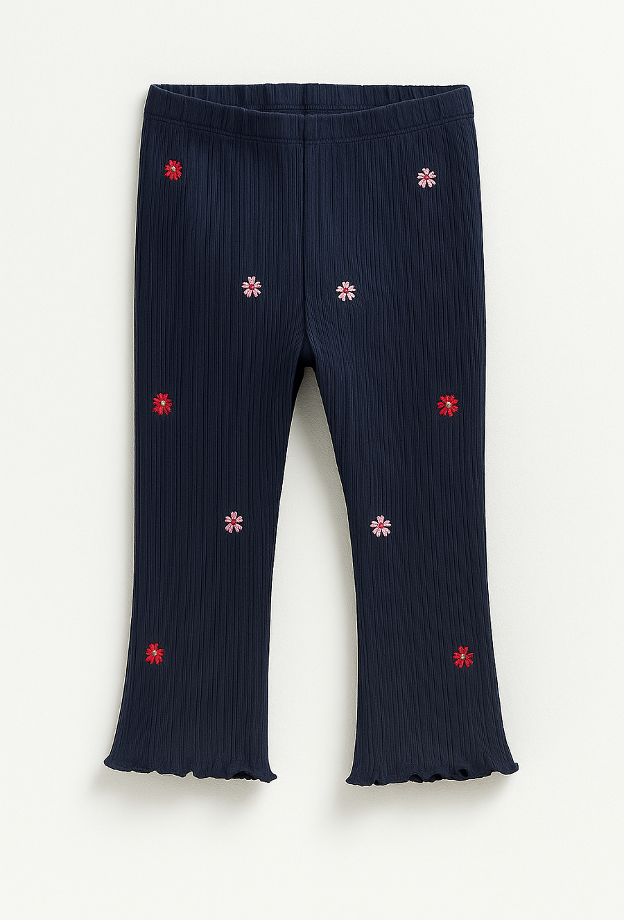 Granatowe legginsy dziewczęce z kwiatowymi naszywkami.