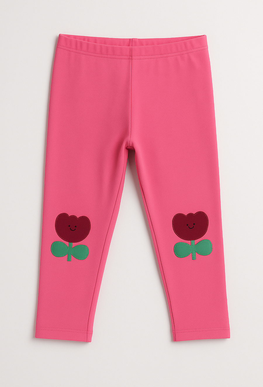 Różowe legginsy niemowlęce z naszywkami kwiatków na kolankach
