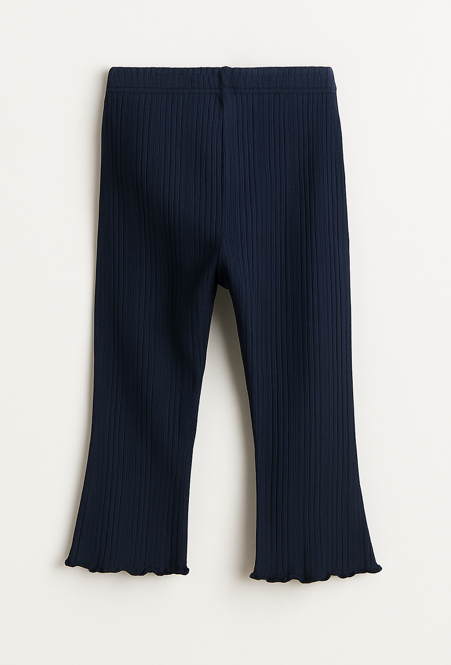 Granatowe legginsy dziewczęce z kwiatowymi naszywkami.