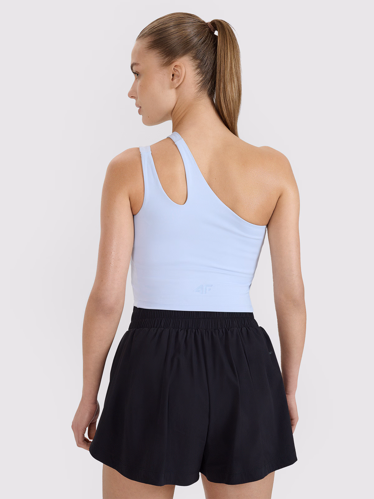 Crop top treningowy na jedno ramię 4F x Anna Lewandowska - niebieski